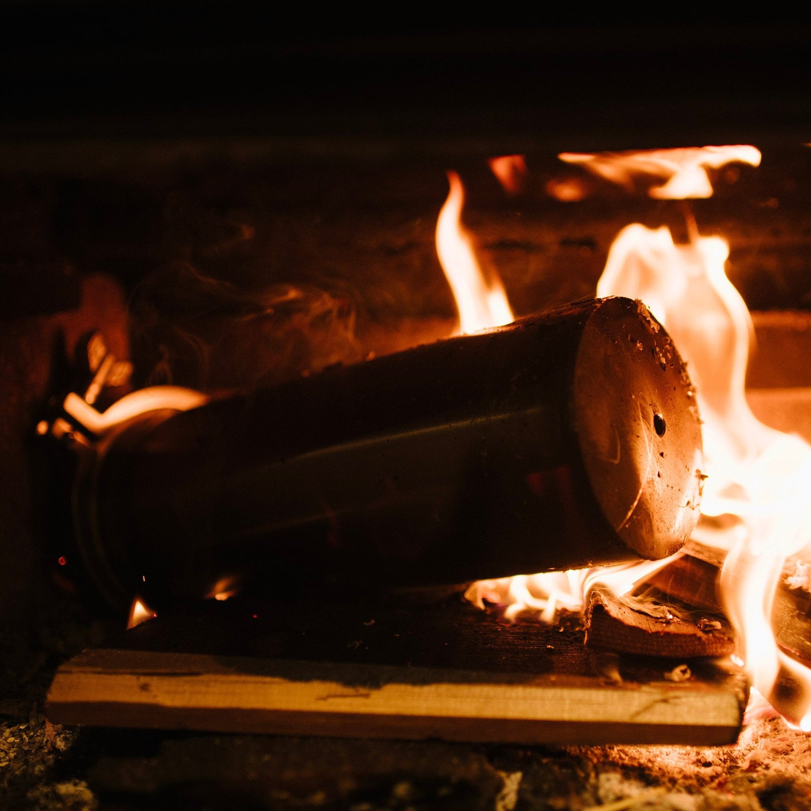 Biochar burning in a fireplace with flames and smoke
