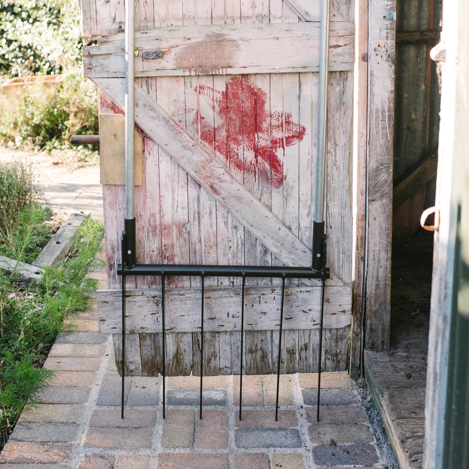 Wooden door with red paint splatter on a rustic outdoor setting