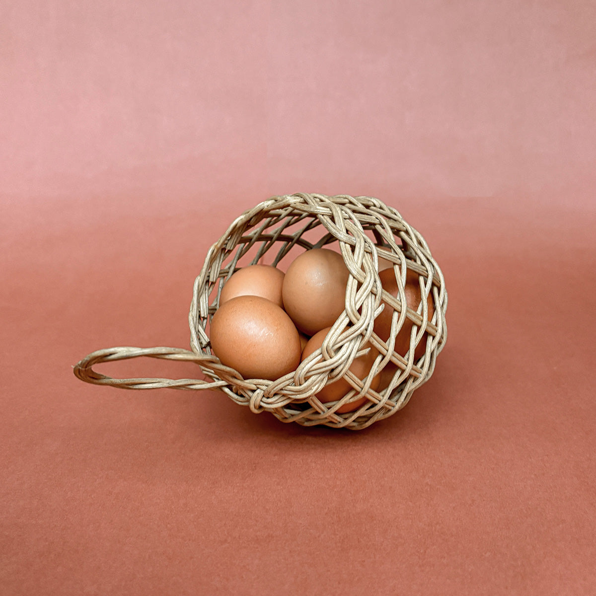 woven rattan egg basket that can hang on a wall