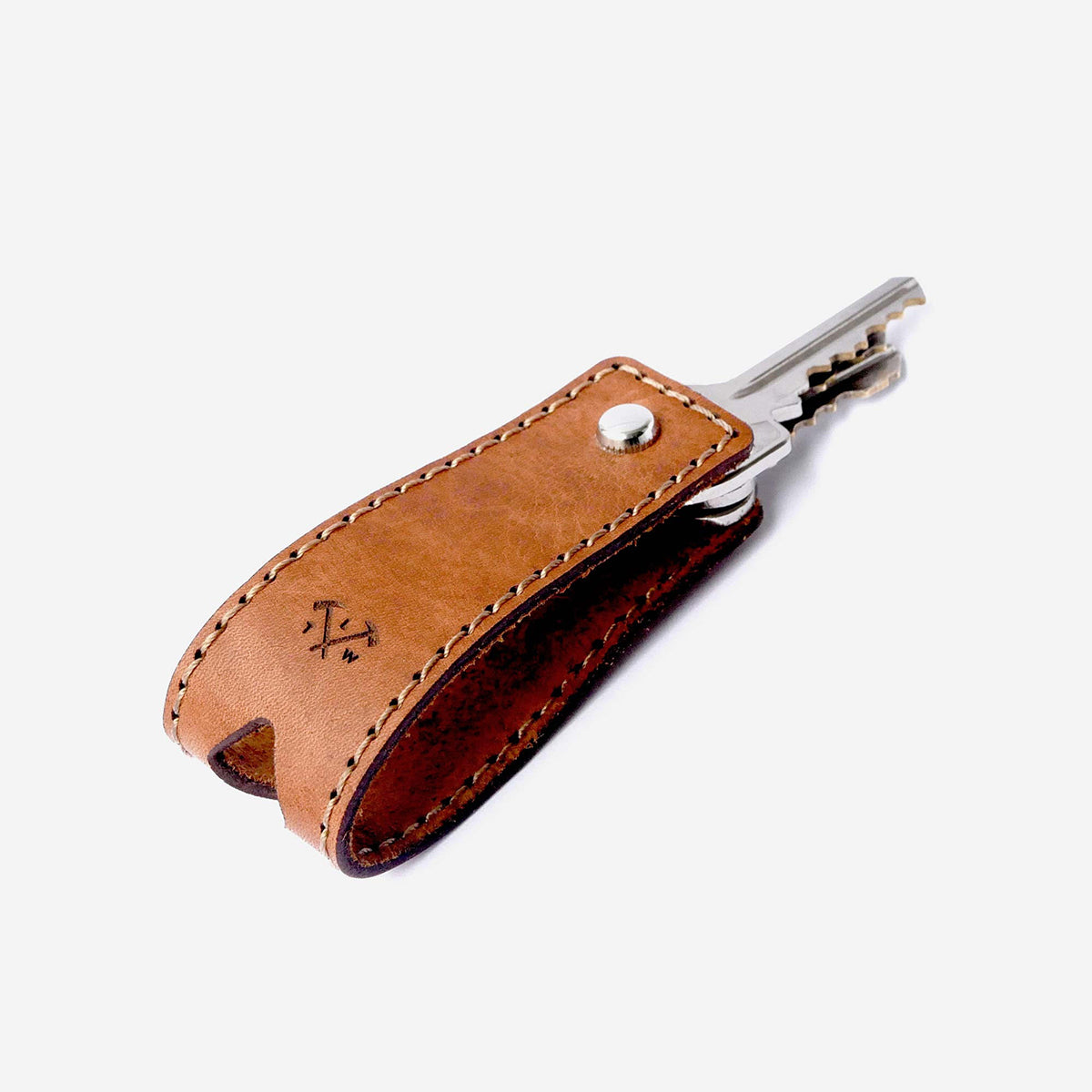 Brown leather keychain with metal key holder on a white background