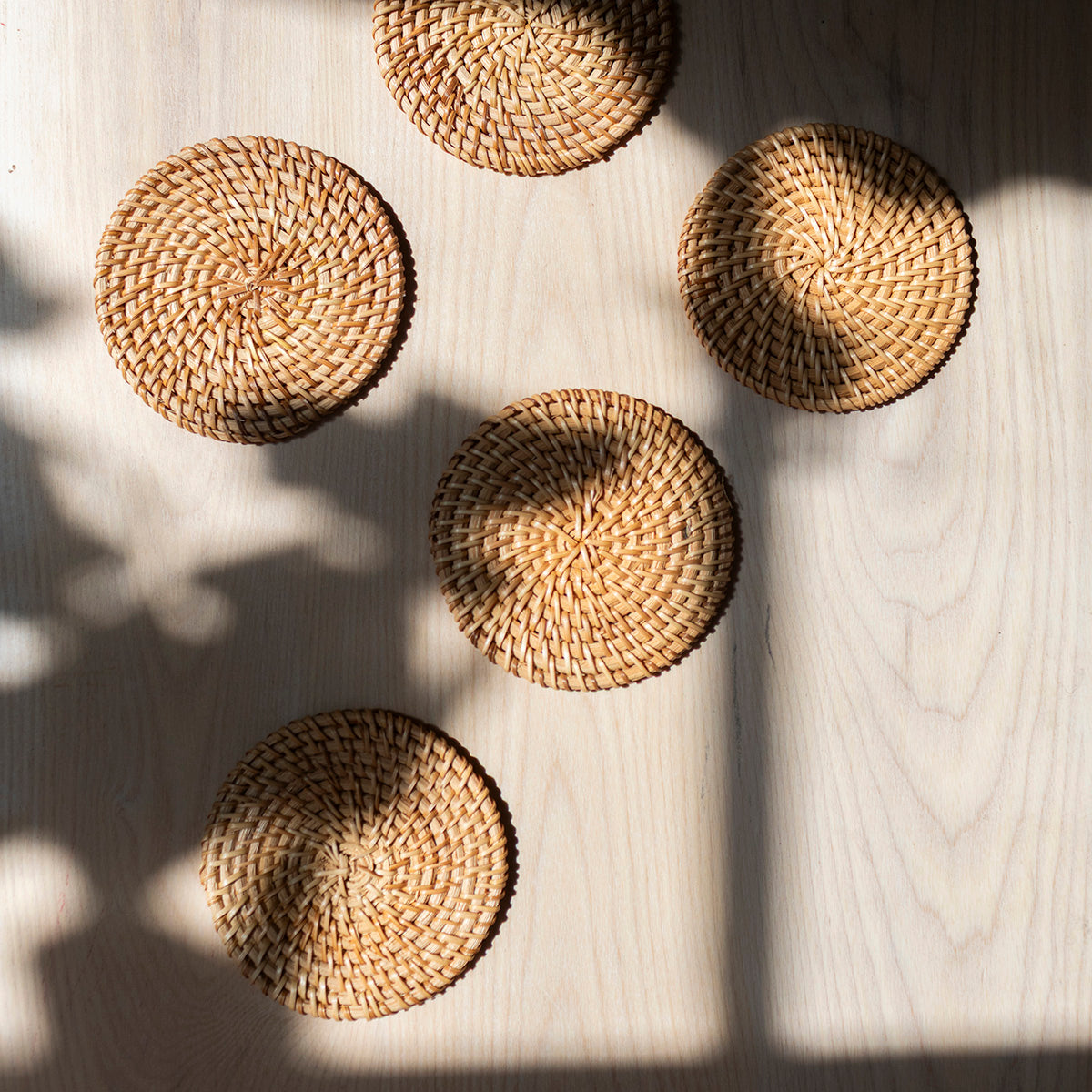 Five round woven coasters