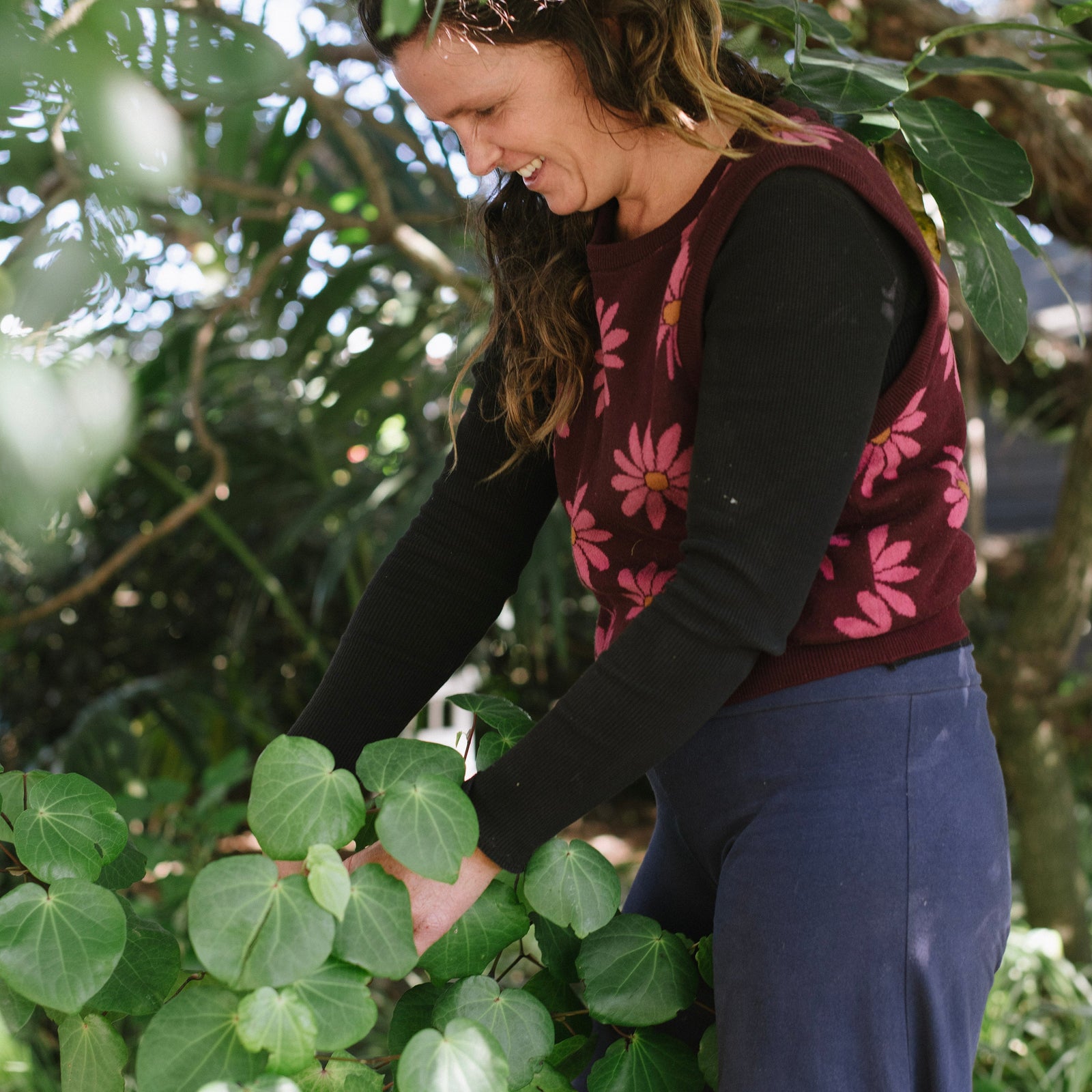 Woman in a garden surrounded by green plants