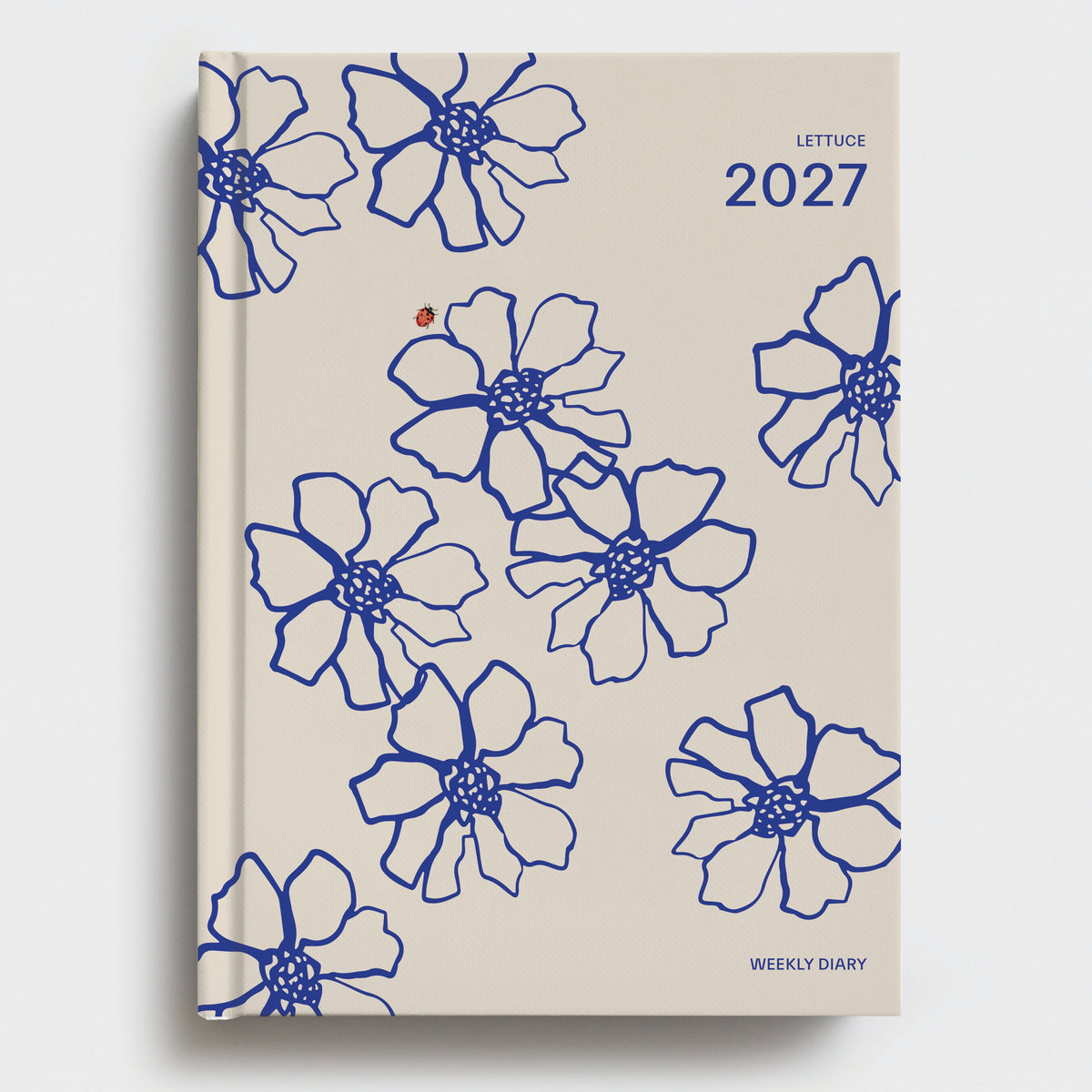 Beige diary with blue floral patterns and '2027' on a white background