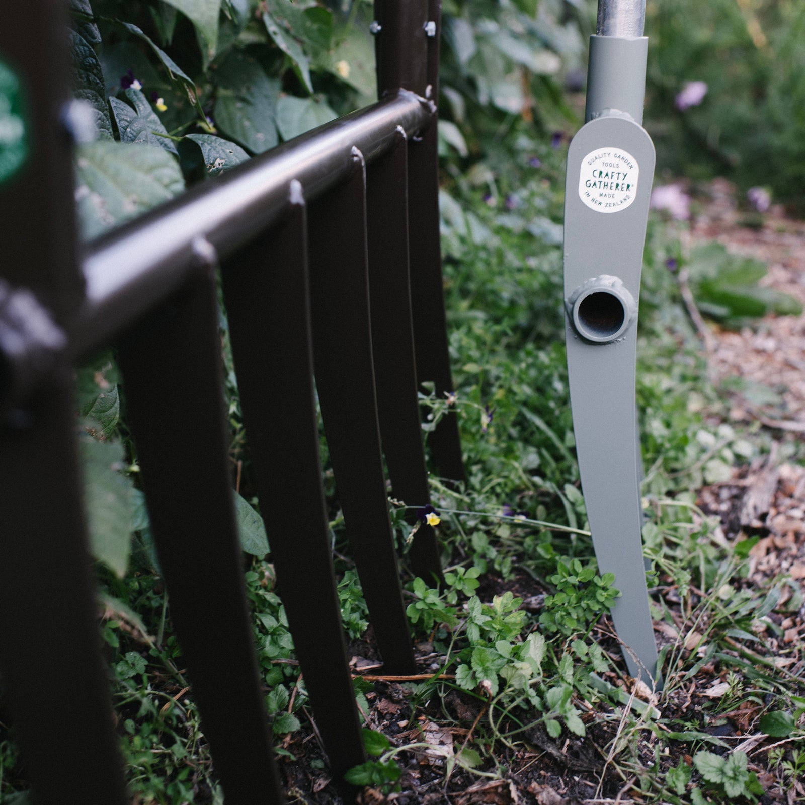 Garden tool with a visible brand label in a garden setting