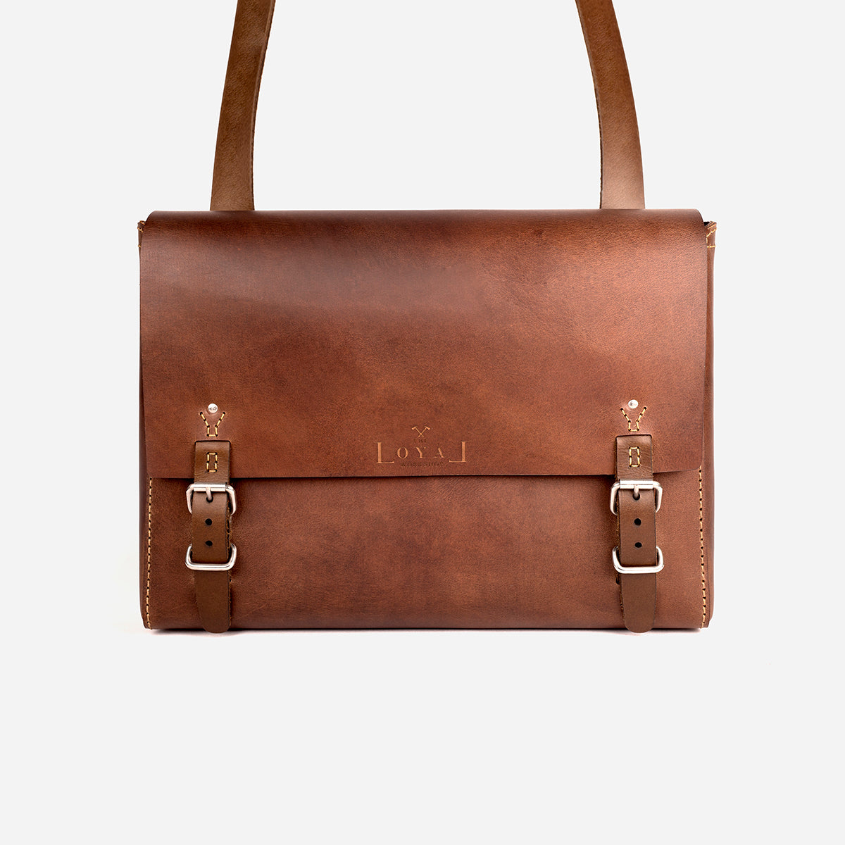 Brown leather bag with silver buckles on a white background