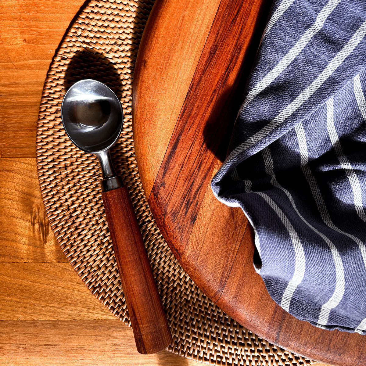 Ice cream scoop with wooden handle on a light background