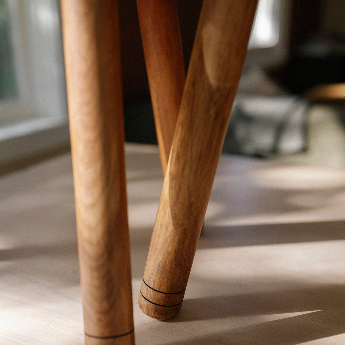 Close-up of wooden chair legs on a blurred background