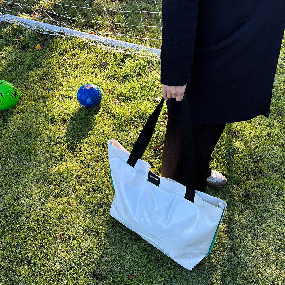 Bright, waterproof bag made from bouncy castle offcuts and expired car seat straps